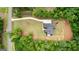 Aerial view of a home on a spacious lot with long driveway and surrounded by trees at 155 Grace Hope Dr, Brooks, GA 30205