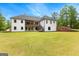 Rear elevation of home featuring an expansive lawn, and covered patios, providing ample space for outdoor enjoyment at 155 Grace Hope Dr, Brooks, GA 30205