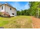 Sprawling backyard with lush greenery and landscaping, adjacent to the home's exterior at 155 Grace Hope Dr, Brooks, GA 30205