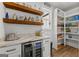 Bar with a mini fridge and pantry featuring built in storage solutions, shelves, and room for supplies at 155 Grace Hope Dr, Brooks, GA 30205