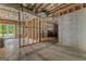 Unfinished basement area, framed and ready for customization, with concrete floor and exposed ceiling at 155 Grace Hope Dr, Brooks, GA 30205