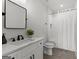 Bathroom with white vanity, marble countertop, black hardware, and tiled tub/shower combo at 155 Grace Hope Dr, Brooks, GA 30205