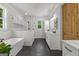 Bright primary bathroom features a tub, walk-in shower, dual vanities, and tiled floors at 155 Grace Hope Dr, Brooks, GA 30205