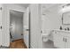 A view into a bathroom and downstairs entryway with white walls and doors, and modern fixtures at 155 Grace Hope Dr, Brooks, GA 30205