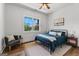 Cozy bedroom with ample natural light, hardwood floors, and a charming sitting area at 155 Grace Hope Dr, Brooks, GA 30205