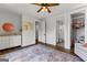 Bedroom features wood floors, a colorful area rug, decor, and access to a private bath at 155 Grace Hope Dr, Brooks, GA 30205