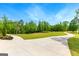 A concrete driveway leads to a large property with lush green lawns and mature trees at 155 Grace Hope Dr, Brooks, GA 30205