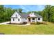 Charming two-story home with a landscaped front yard, brick stairs, and covered porch at 155 Grace Hope Dr, Brooks, GA 30205