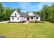 Stunning two-story home with white siding, black trim, a dark roof, and a well-manicured lawn at 155 Grace Hope Dr, Brooks, GA 30205