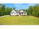 Stunning two-story home with white siding, black trim, a dark roof, and a well-manicured lawn at 155 Grace Hope Dr, Brooks, GA 30205