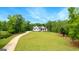 Secluded farmhouse featuring an extra long driveway and sprawling front yard bordered by a densely wooded lot at 155 Grace Hope Dr, Brooks, GA 30205