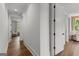 Hallway featuring hardwood floors, white walls, and access to other rooms at 155 Grace Hope Dr, Brooks, GA 30205