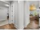 Hallway view with access to the Primary bedroom, featuring wood floors and white walls and trim at 155 Grace Hope Dr, Brooks, GA 30205