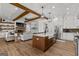 Open concept kitchen that flows into the living room, featuring stainless steel appliances and a large island at 155 Grace Hope Dr, Brooks, GA 30205