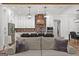 Stunning kitchen featuring white cabinets, brick backsplash, wooden accents, and stainless steel appliances at 155 Grace Hope Dr, Brooks, GA 30205
