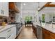 Bright, spacious kitchen features a brick backsplash, stainless steel appliances, and an open view to the dining area at 155 Grace Hope Dr, Brooks, GA 30205