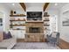 Bright living room featuring shiplap, wood shelves, stone fireplace and recessed lighting at 155 Grace Hope Dr, Brooks, GA 30205