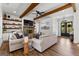 Spacious living room features exposed beams, shiplap, stone fireplace, and hardwood floors at 155 Grace Hope Dr, Brooks, GA 30205