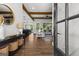 Open-concept living room with hardwood floors, wood beam ceiling, and contemporary decor at 155 Grace Hope Dr, Brooks, GA 30205