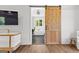 Stylish bathroom with wood door, black tile floors, a soaking tub and large windows with natural light at 155 Grace Hope Dr, Brooks, GA 30205