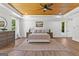 Bright bedroom with hardwood floors, decorative wood ceiling, natural light, and neutral color palette at 155 Grace Hope Dr, Brooks, GA 30205