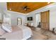 Bedroom featuring a wood ceiling, hardwood floors, modern furnishings and sliding door to the bathroom at 155 Grace Hope Dr, Brooks, GA 30205