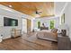 Spacious main bedroom with hardwood floors, wood plank ceiling, fan, and ensuite bathroom access at 155 Grace Hope Dr, Brooks, GA 30205
