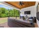 Covered patio with wicker furniture, wooded ceiling, outdoor seating, and a view of surrounding greenery at 155 Grace Hope Dr, Brooks, GA 30205