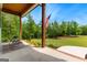 Relaxing front porch view with rocking chairs, a flag, and a serene view of the landscaped yard at 155 Grace Hope Dr, Brooks, GA 30205