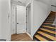 A staircase with wood treads and gray risers ascends in this home's interior, beside a closet at 155 Grace Hope Dr, Brooks, GA 30205