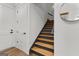 A staircase with wood treads and gray risers ascends in this home's interior, beside doors and a round mirror at 155 Grace Hope Dr, Brooks, GA 30205