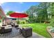 Backyard featuring a patio with seating and a red umbrella at 1533 High Haven Ne Ct, Atlanta, GA 30329