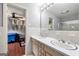 Bathroom featuring a double sink vanity and access to bedroom and glass enclosed shower at 1533 High Haven Ne Ct, Atlanta, GA 30329
