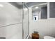 Bathroom with white tile walls and a glass enclosed shower at 1533 High Haven Ne Ct, Atlanta, GA 30329