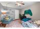 Cozy bedroom with hardwood floors, ceiling fan, game system graphic, and comfortable bed at 1533 High Haven Ne Ct, Atlanta, GA 30329