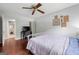 Bedroom with wood floors, ceiling fan, neutral walls, and attached bathroom at 1533 High Haven Ne Ct, Atlanta, GA 30329