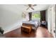 Bedroom featuring hardwood floors, a ceiling fan, and a window with dark curtains at 1533 High Haven Ne Ct, Atlanta, GA 30329
