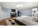 Spacious bedroom features hardwood floors, dresser, television, and a comfortable bed at 1533 High Haven Ne Ct, Atlanta, GA 30329