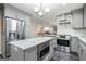 Modern kitchen with stainless steel appliances, a granite-topped island, and stylish gray cabinetry at 1533 High Haven Ne Ct, Atlanta, GA 30329