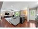 Spacious living room with wood floors, a cozy sectional sofa, and a large window for natural light at 1533 High Haven Ne Ct, Atlanta, GA 30329