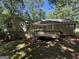 This house features a large deck and a spacious backyard bordered by lush trees, offering privacy at 261 Sally Duke Dr, Whitesburg, GA 30185