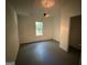 This bedroom has a chandelier and a window offering natural light at 261 Sally Duke Dr, Whitesburg, GA 30185