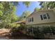 This beautiful home is surrounded by lush greenery, complemented by a cozy deck and a satellite dish at 261 Sally Duke Dr, Whitesburg, GA 30185
