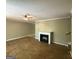 Spacious living room with a decorative fireplace and ceiling fan, offering potential for customization at 261 Sally Duke Dr, Whitesburg, GA 30185