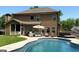 Backyard with a pristine pool, patio furniture, and a hot tub, perfect for entertaining at 8340 Nolandwood Ln, Villa Rica, GA 30180