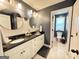 Modern bathroom featuring double vanity, round mirrors, updated fixtures, and decorative chevron backsplash at 8340 Nolandwood Ln, Villa Rica, GA 30180