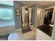 Bright bathroom boasting a soaking tub, glass shower with white curtains, and access to a walk-in closet at 8340 Nolandwood Ln, Villa Rica, GA 30180