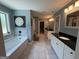 Large bathroom with double vanities, a soaking tub, decorative mirror and easy access to the spacious walk-in closet at 8340 Nolandwood Ln, Villa Rica, GA 30180