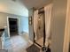 Modern bathroom featuring tile floors, a glass-enclosed shower, and a separate soaking tub for a spa-like experience at 8340 Nolandwood Ln, Villa Rica, GA 30180