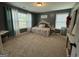 This bedroom offers ample natural light, neutral walls, and plush carpeting, creating a cozy and bright space at 8340 Nolandwood Ln, Villa Rica, GA 30180